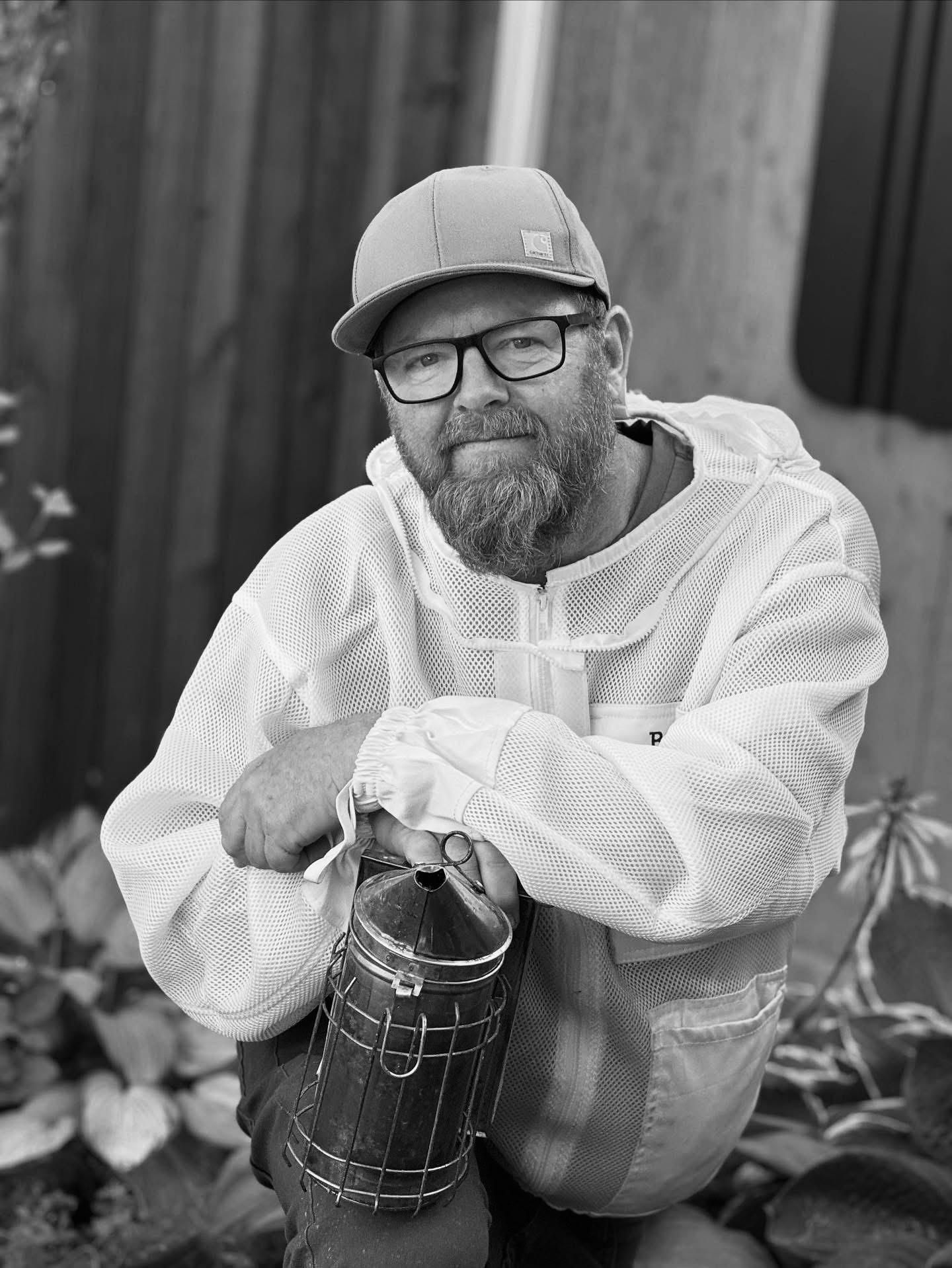 Mark Vanderende, Master Beekeeper and keynote speaker, in his beekeeping jacket with smoker in hand